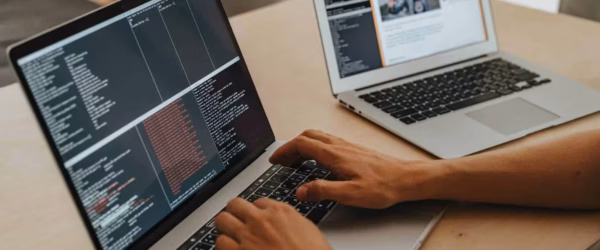 person coding on a macbook pro