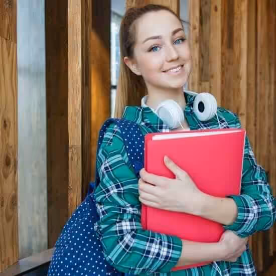woman standing in hallway while holding book