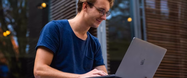 selective focus photo of man using laptop