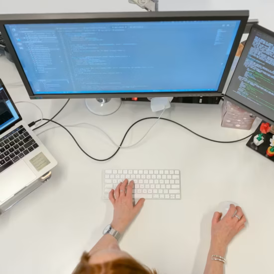 female software engineer coding on computer
