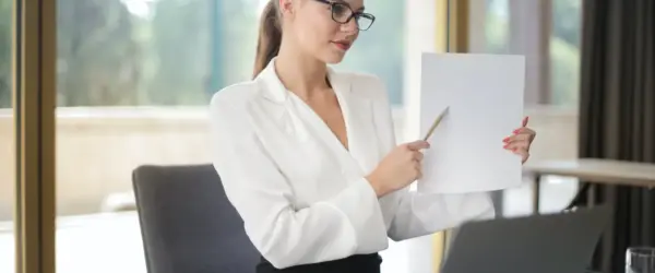 confident businesswoman sharing information from documents in workplace