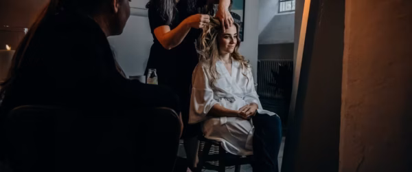 hairstylist fixing her client s hair