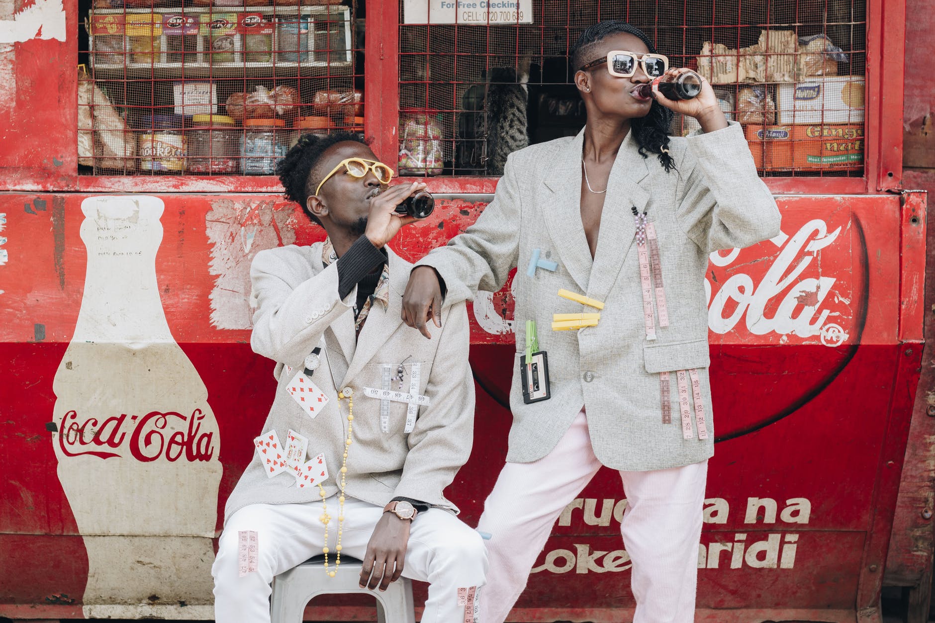 two person drinking coca cola next to a kiosk - How to Dominate Your Niche