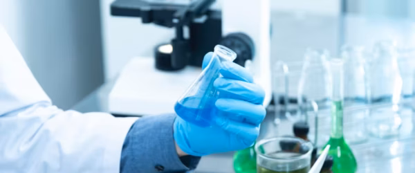 person holding laboratory flask