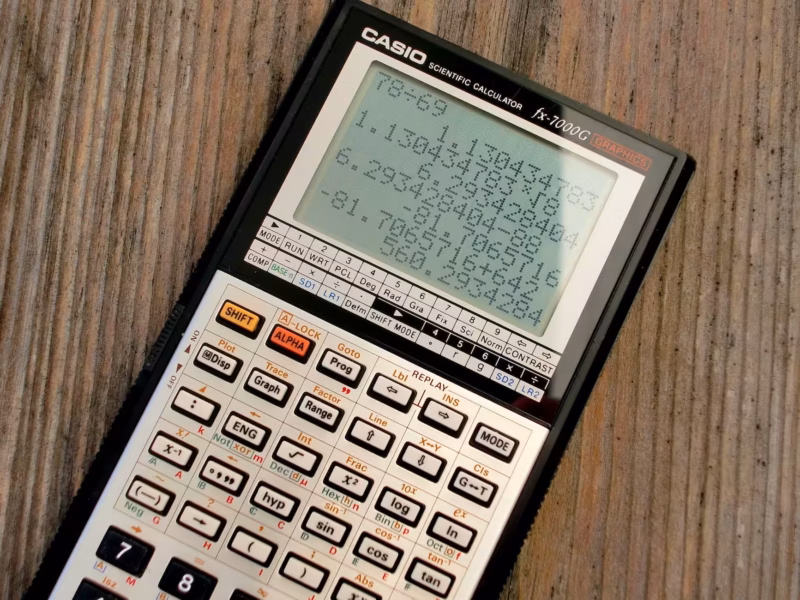 scientific calculator on wooden surface