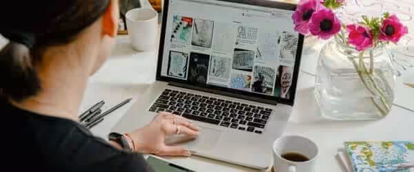 photo of person using laptop for graphic designs