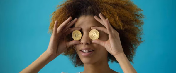 woman holding two coins