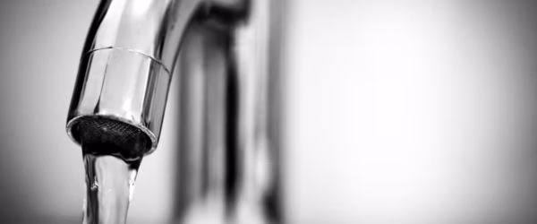 macro photography of a stainless steel faucet