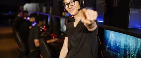 man in black shirt wearing black headphones while smiling