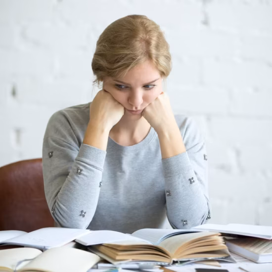 portrait tired student woman desk