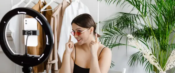 a woman showing her sunglasses to a video recording