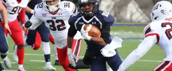 football player carrying brown football