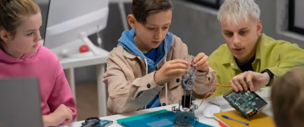 Children engaged in STEM robotics project.