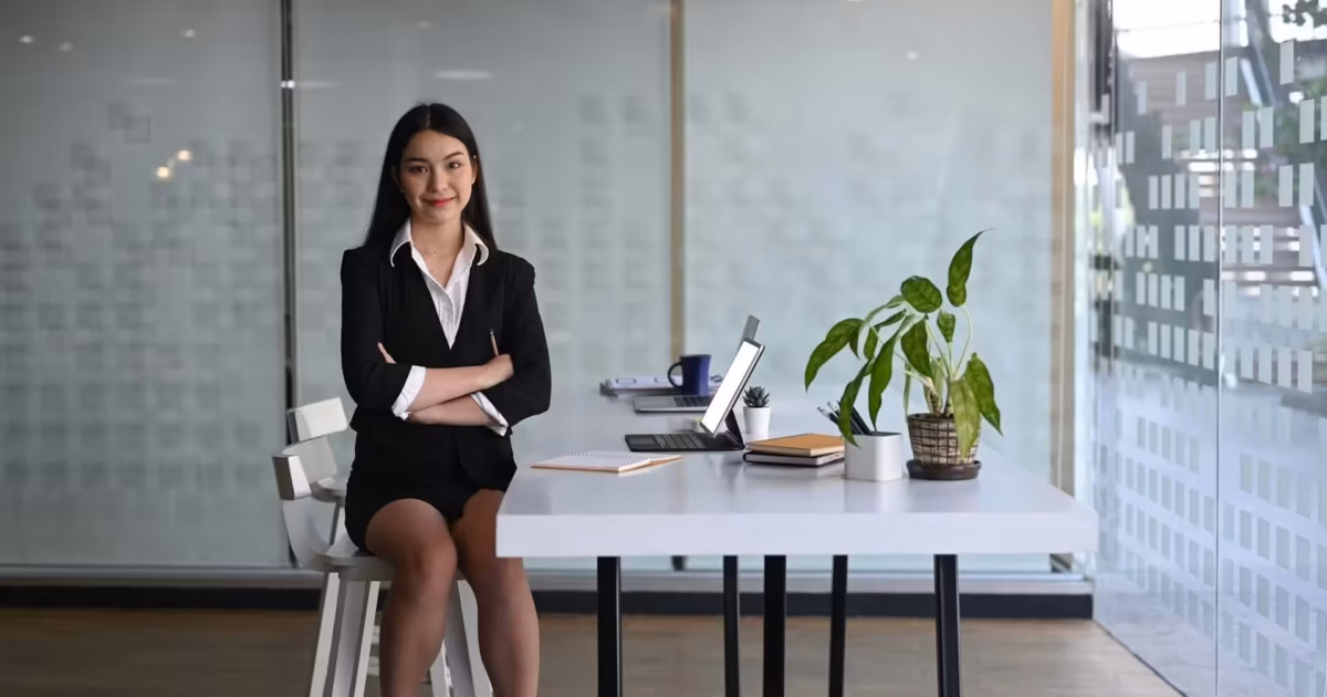 Businesswoman sitting confidently at desk.