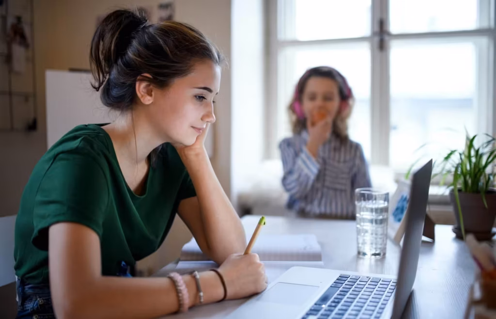 Woman working at a desk, child nearby.