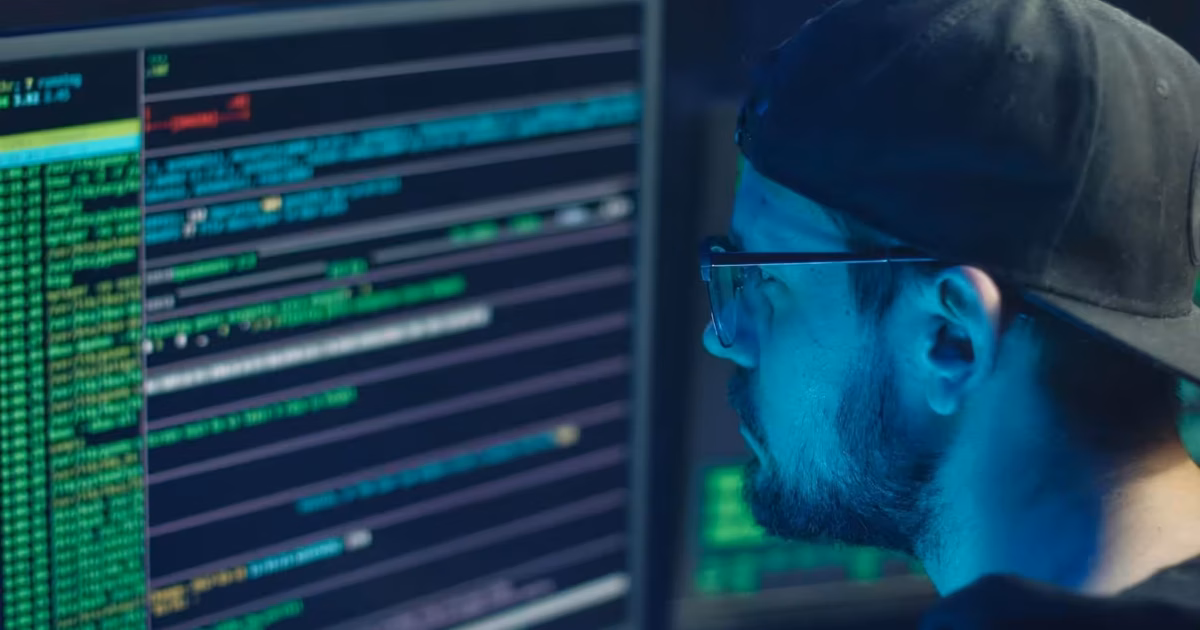 Person coding with multiple computer screens.