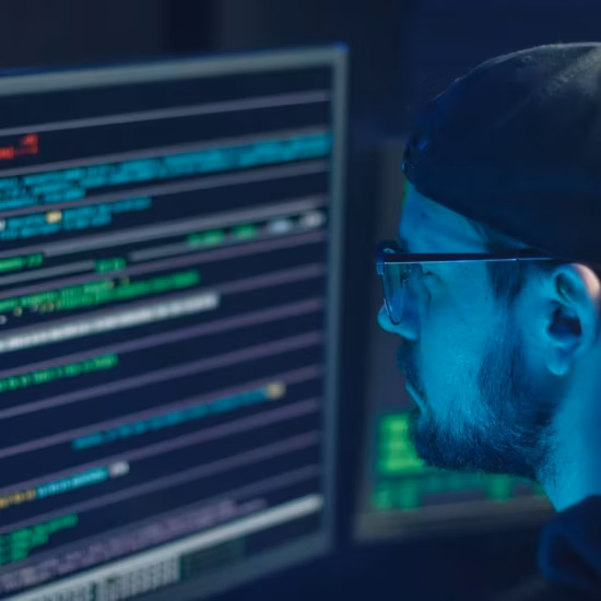 Person coding with multiple computer screens.