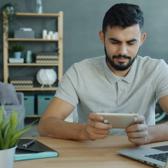 Happy Moddle Eastern man is playing video game