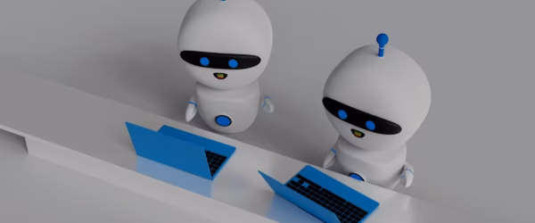 Two robots working on laptops