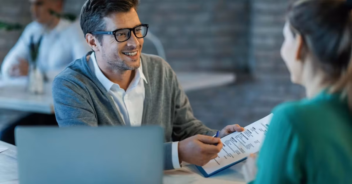 Business meeting with document discussion.