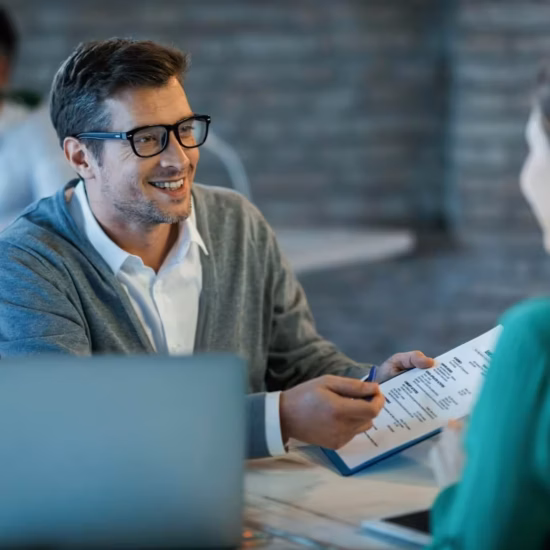 Business meeting with document discussion.