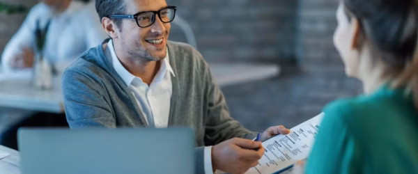 Business meeting with document discussion.