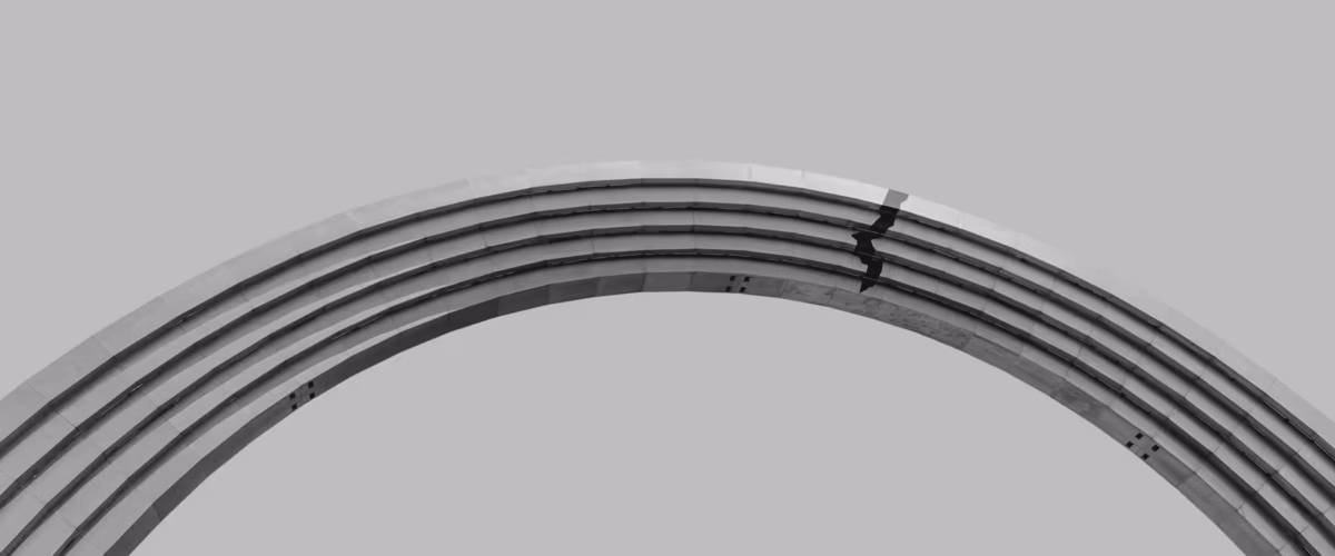 Curved architectural structure in grayscale.