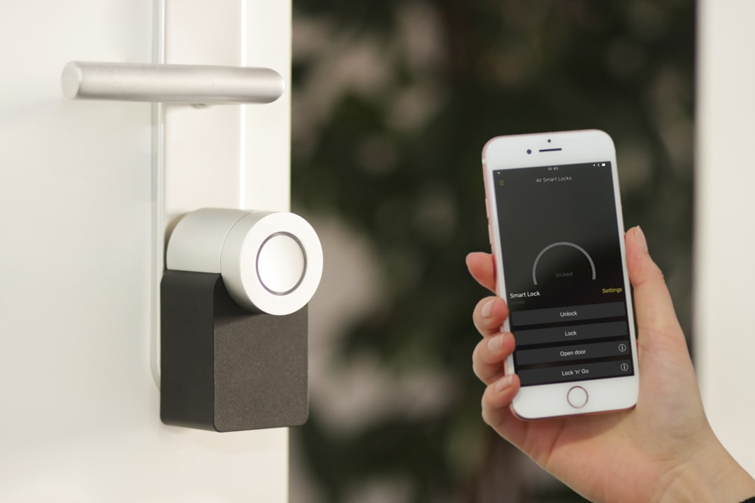 Smart lock on door being controlled by iPhone app showing lock and unlock options
