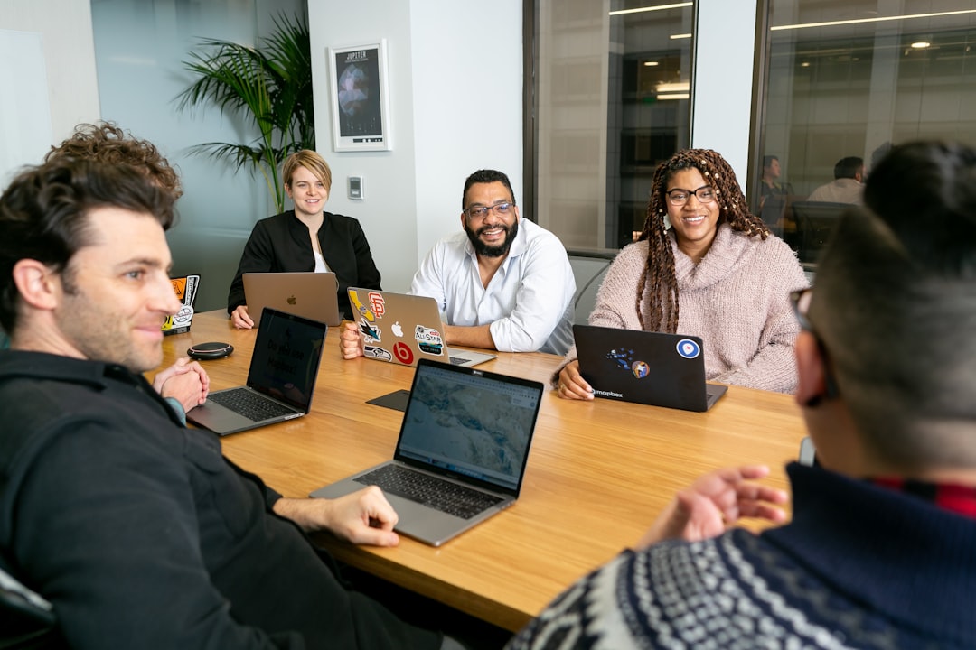 Team in a board meeting representing Amanet professional development and management training