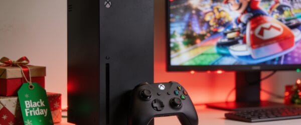 Xbox Series X console with controller and a Black Friday gift tag on a festive desk