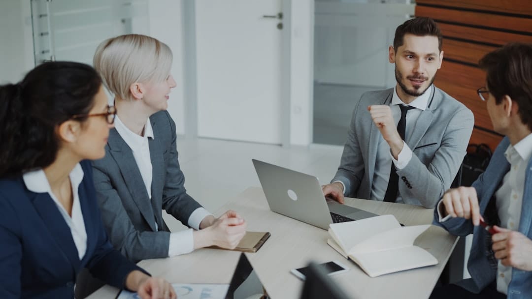 Team collaborating on a shared customer email in a business meeting