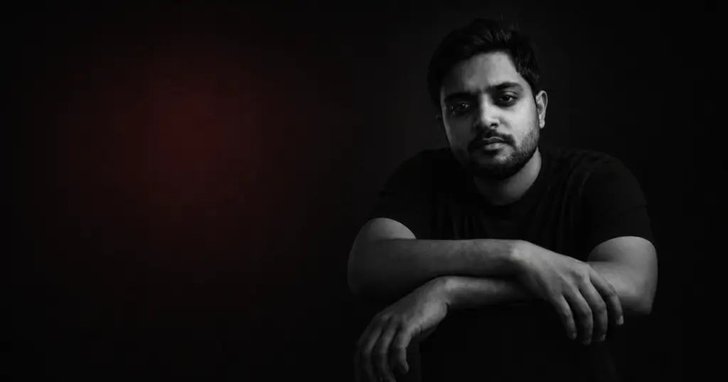 Gaurav Tiwari in a monochrome portrait against a dark background with a subtle red glow
