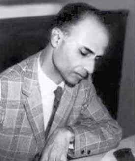 Indian American mathematician Harish-Chandra working at a desk