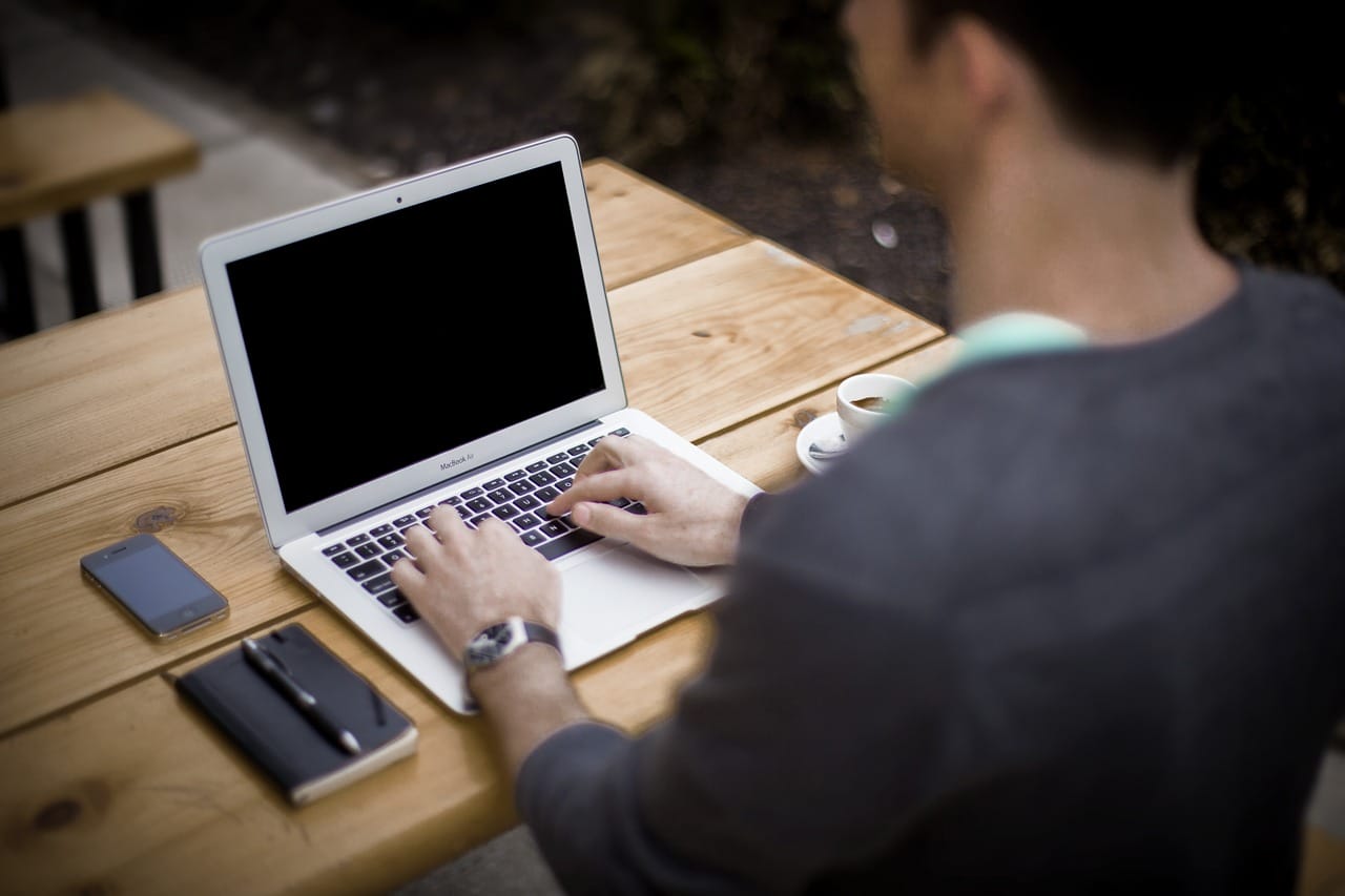 Blog writer working on an article at a laptop