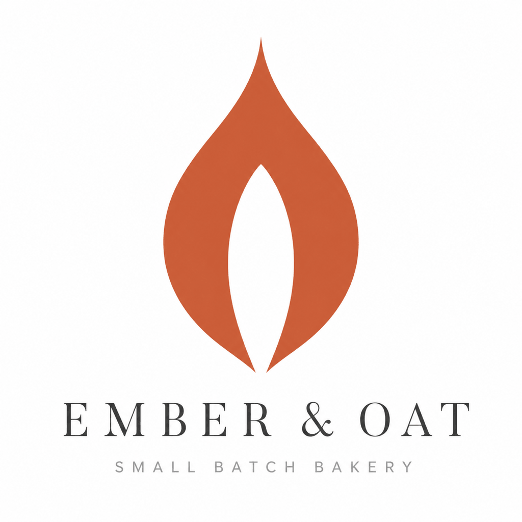 Refined Ember and Oat logo: terracotta flame with an oat grain in its negative space above a serif wordmark