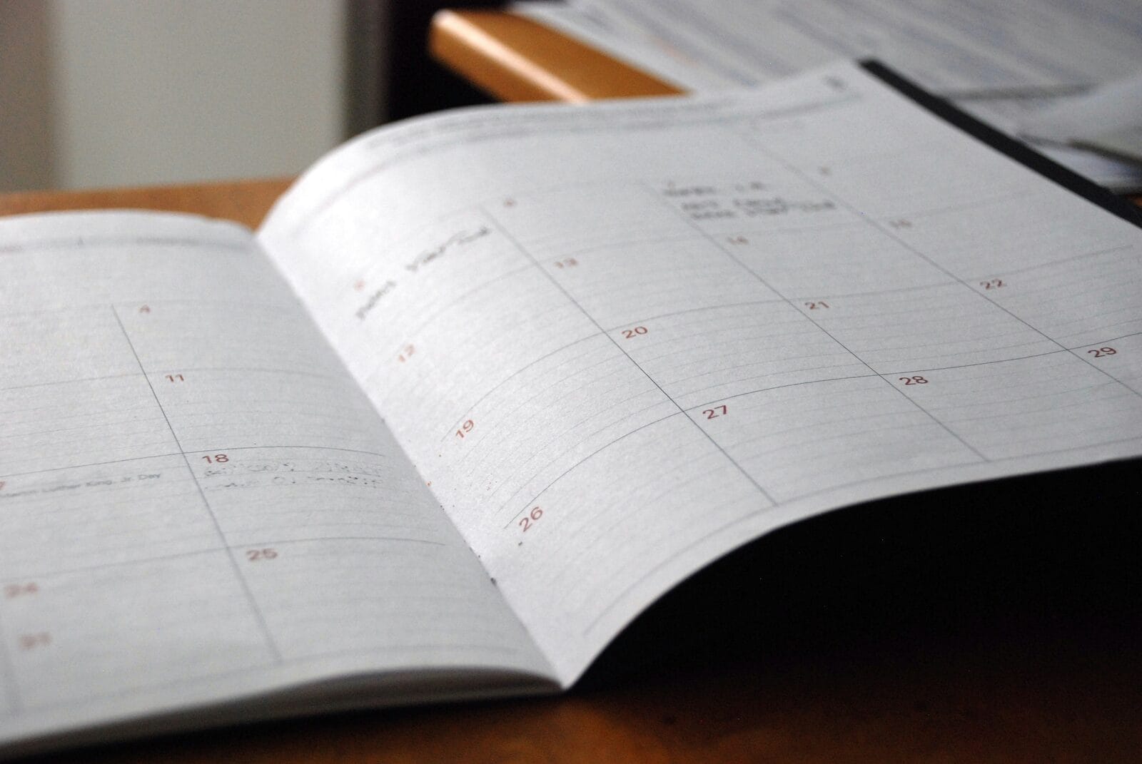 An open monthly paper planner used to schedule an MCAT test date and study phases