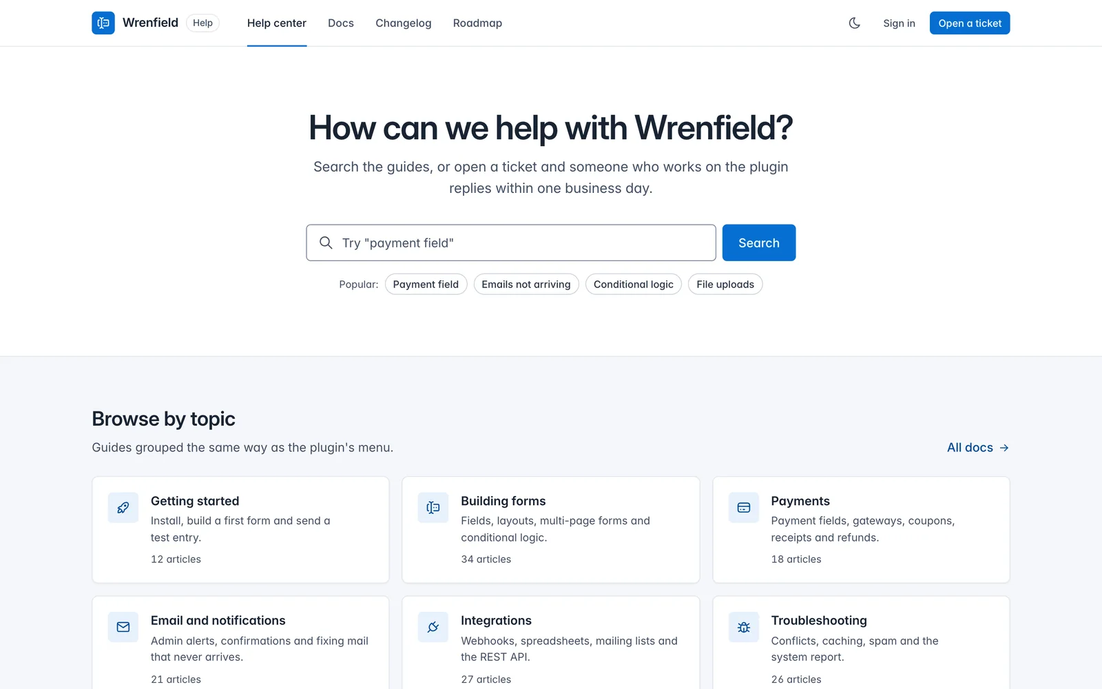 Core Support design system demo in light mode: a help center for a sample WordPress form plugin called Wrenfield, with a search field, popular topics and topic cards.